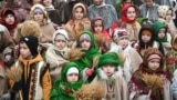 Children wearing traditional clothes carry 'didukh' as they take part in a Christmas Eve procession in Lviv, Dec. 24, 2024, amid the Russian invasion of Ukraine. 