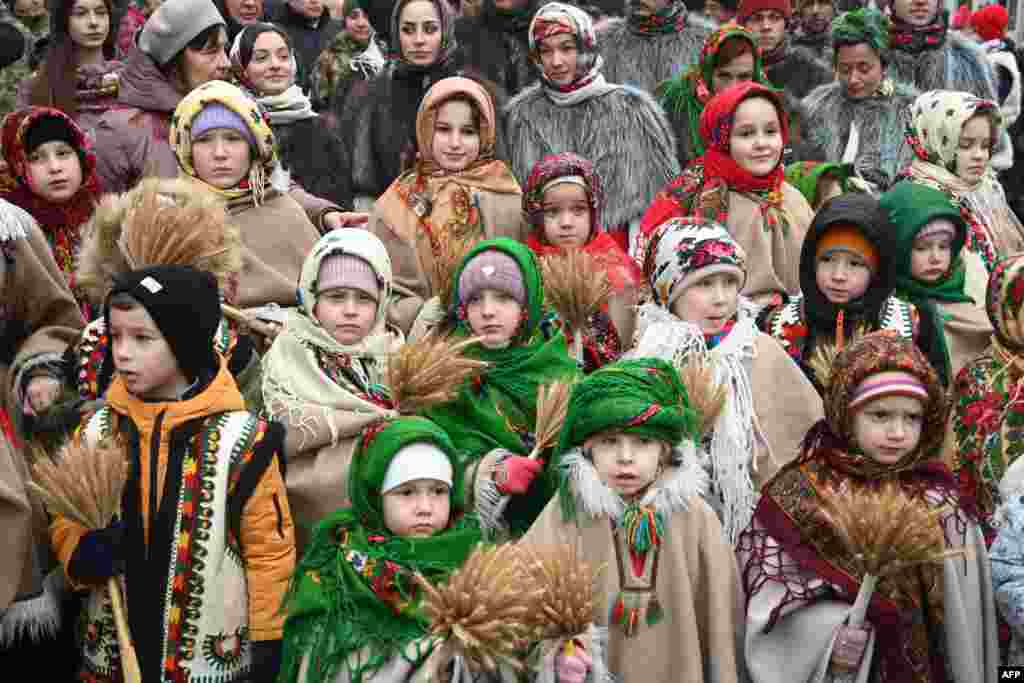 Children wearing traditional clothes carry &#39;didukh&#39; as they take part in a Christmas Eve procession in Lviv amid the Russian invasion of Ukraine.&nbsp;&#39;Didukh&#39; is a Ukrainian Christmas decoration made of bunches of wheat, symbolizing sacrifice and literally meaning &#39;spirit of grandfather.&#39;