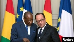 Le président français François Hollande écoute son homologue guinéen Alpha Conde au Palais de l'Élysée, à Paris, le 11 avril 2017.