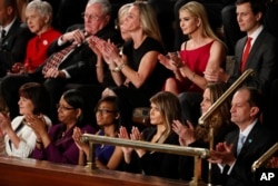 First Lady Melania Trump (bottom row, third from right) and guests applaud on Capitol Hill in Washington, Feb. 28, 2017, during President Donald Trump's address to a joint session of Congress.