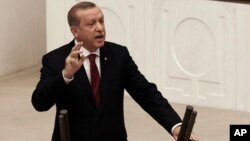 Turkey's President Recep Tayyip Erdogan addresses the parliament in Ankara, Turkey, on Oct. 1, 2016. Erdogan hinted on Thursday that the three-month state of emergency declared following the failed July 15 coup could be extended to more than a year. 