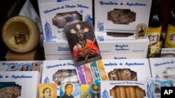 FILE - Handmade sweets made by the cloistered nuns of the Monjas Minimas monastery are displayed for sale at the door of a church in Jerez de la Frontera, southern Spain, on December 5, 2023.