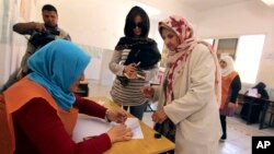 Defying the turmoil roiling their nation Libyans vote in parliament elections in Benghazi, Libya, Wednesday, June 25, 2014. 