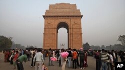 A man sells candy floss in front of the India Gate national monument in New Delhi, India, Dec. 12, 2011.