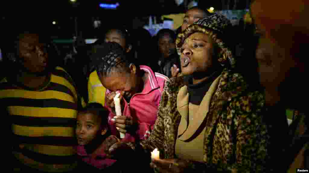 Wellwishers hold candles as they gather in support of Mandela.