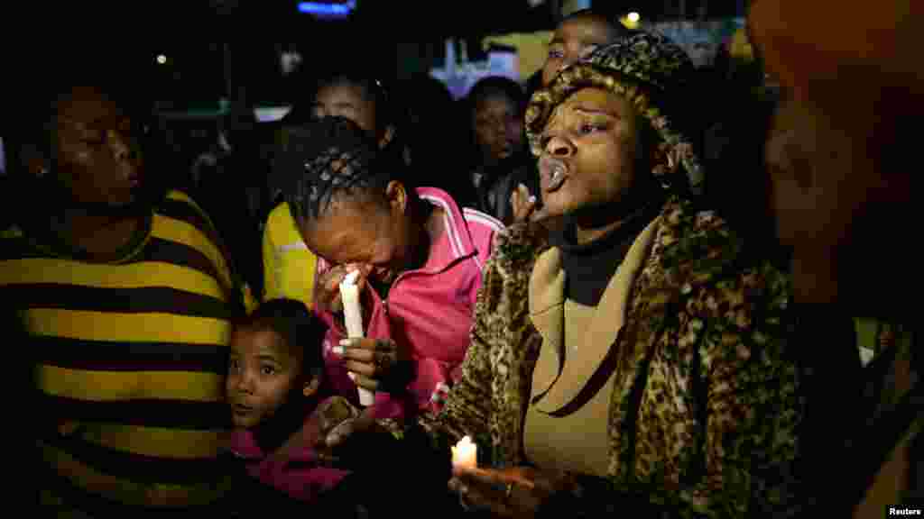 Wellwishers hold candles as they gather in support of Mandela.