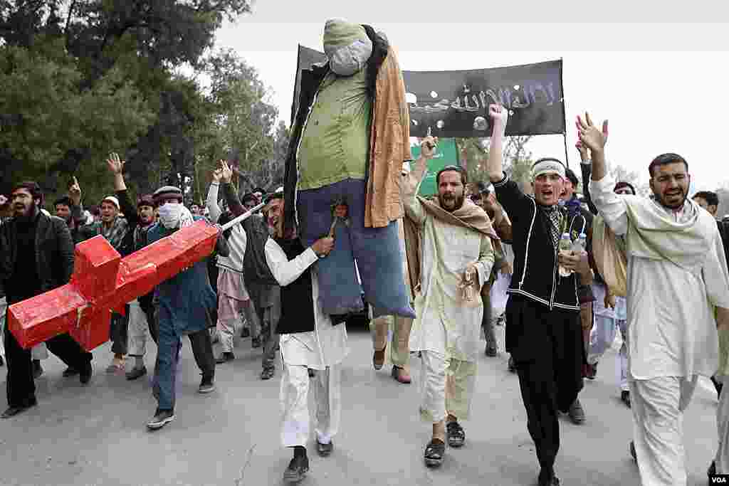 Afghans chant anti U.S. slogans as they carry an effigy depicting U.S. President Barack Obama during a protest in Jalalabad. (AP)