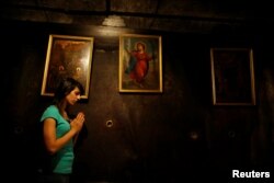 Palestinian swimmer Mary Al-Atrash, 22, who will represent Palestine at the 2016 Rio Olympics, prays at The Church of the Nativity in the West Bank town of Bethlehem, June 27, 2016.