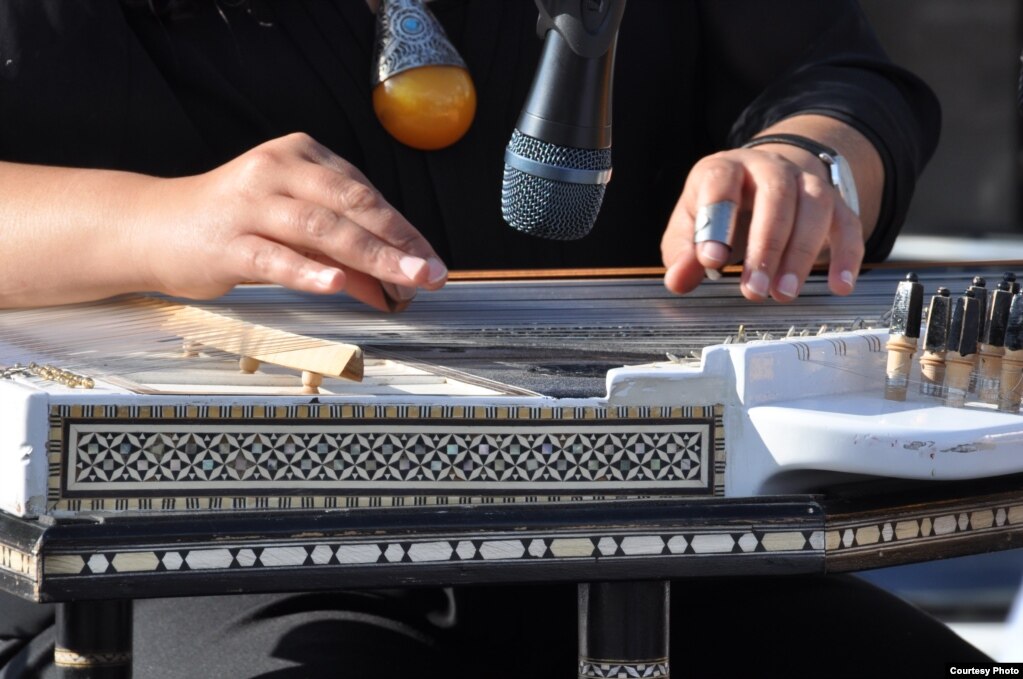 The Arabic qanun, a Middle Eastern string instrument resembling the western zither, is played by artist Huda Asfour during Syria Fest in Washington, Sept. 3, 2017. (Photo courtesy of Rabah Seba)