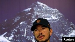 FILE - Nirmal Purja, attempting a record to climb fourteen 8000-meter mountain peaks in seven months speaks during a news conference after climbing six mountains including Mt. Everest in Kathmandu, Nepal, May 28, 2019. 