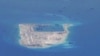 FILE - Chinese dredging vessels are purportedly seen around Fiery Cross Reef in the disputed Spratly Islands in the South China Sea in this image from video taken by a P-8A Poseidon surveillance aircraft provided by the U.S. Navy, May 21, 2015. 