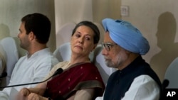 India’s outgoing Prime Minister Manmohan Singh, right, Congress party president Sonia Gandhi, center, and her son and party vice president Rahul Gandhi, attend a meeting of the Congress Working Committee to review the party’s defeat in the general electio
