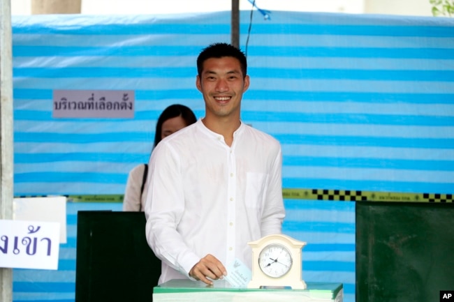 FILE - Thanathorn Juangroongruangkit, leader of Future Forward Party, poses as he casts his vote during general election at a polling station in Bangkok, March 24, 2019.