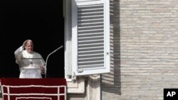 Pope Francis delivers a blessing during his Angelus prayer from his studio window overlooking St. Peter's Square, at the Vatican, Nov. 10, 2019.