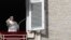 Pope Francis delivers a blessing during his Angelus prayer from his studio window overlooking St. Peter's Square, at the Vatican, Nov. 10, 2019.