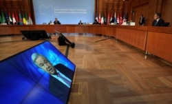 FILE - United Nations Secretary-General Antonio Guterres speaks on screen at the beginning of the Second Berlin Conference on peace in Libya at the German Foreign Ministry in Berlin, June 23, 2021.