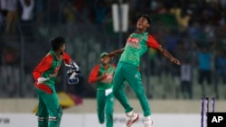 Bangladesh’s Mustafizur Rahman, right, celebrates with his teammate Litton Das, the dismissal of India’s Ravindra Jadeja during their second one-day international cricket match in Dhaka, Bangladesh, Sunday, June 21, 2015. 