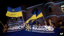 Supporters of presidential candidate Fabricio Alvarado with the National Restoration party gather before a debate ahead of the presidential election in San Jose, Costa Rica, Feb. 1, 2018. Costa Ricans head to the polls Sunday.