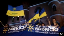 Supporters of presidential candidate Fabricio Alvarado with the National Restoration party gather before a debate ahead of the presidential election in San Jose, Costa Rica, Feb. 1, 2018. Costa Ricans head to the polls Sunday.