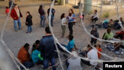 Migrants from Central America wait inside an enclosure, where they are being held by U.S. Customs and Border Protection, after crossing the U.S.-Mexico border illegally and turning themselves in to request asylum, in El Paso, Texas, March 29, 2019.