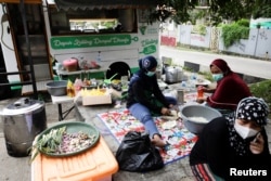 Relawan "Dompet Dhuafa" menyiapkan makanan gratis untuk dibagikan kepada pasien COVID-19 yang menjalani isolasi mandiri di Tangsel, pinggiran Jakarta, Indonesia (foto: ilustrasi).