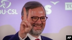Petr Fiala, leader of the center-right Spolu (Together) coalition, flashes the "V" sign as he reacts to results at the party's election headquarters, Prague, Czech Republic, Oct. 9, 2021.