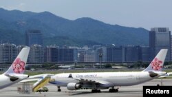 FILE - China Airlines airplanes are parked on the tarmac at Songshan Airport in Taipei, Taiwan, June 24, 2016.