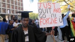FILE: A jobless university graduate poses for a photo while holding a banner with a message directed at Zimbabwean President Robert Mugabe during protests in Harare on Aug. 3, 2016.