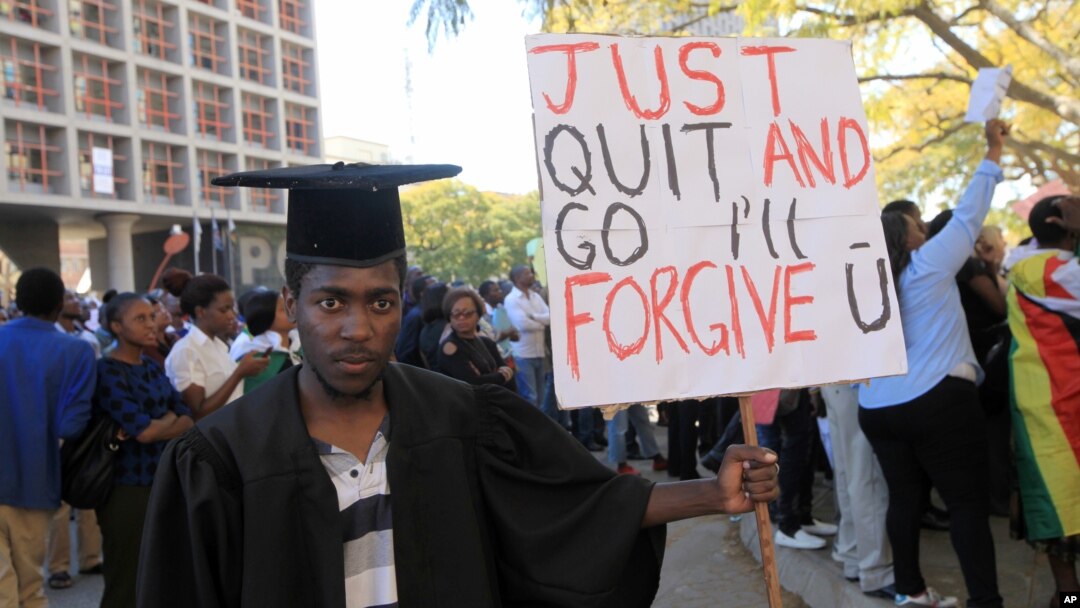 FILE - A jobless university graduate protests while holding a banner with a message directed at Zimbabwean President Robert Mugabe during protests in Harare, Aug. 3, 2016.