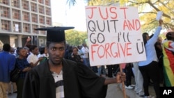 FILE - A jobless university graduate protests while holding a banner with a message directed at Zimbabwean President Robert Mugabe during protests in Harare, Aug. 3, 2016.