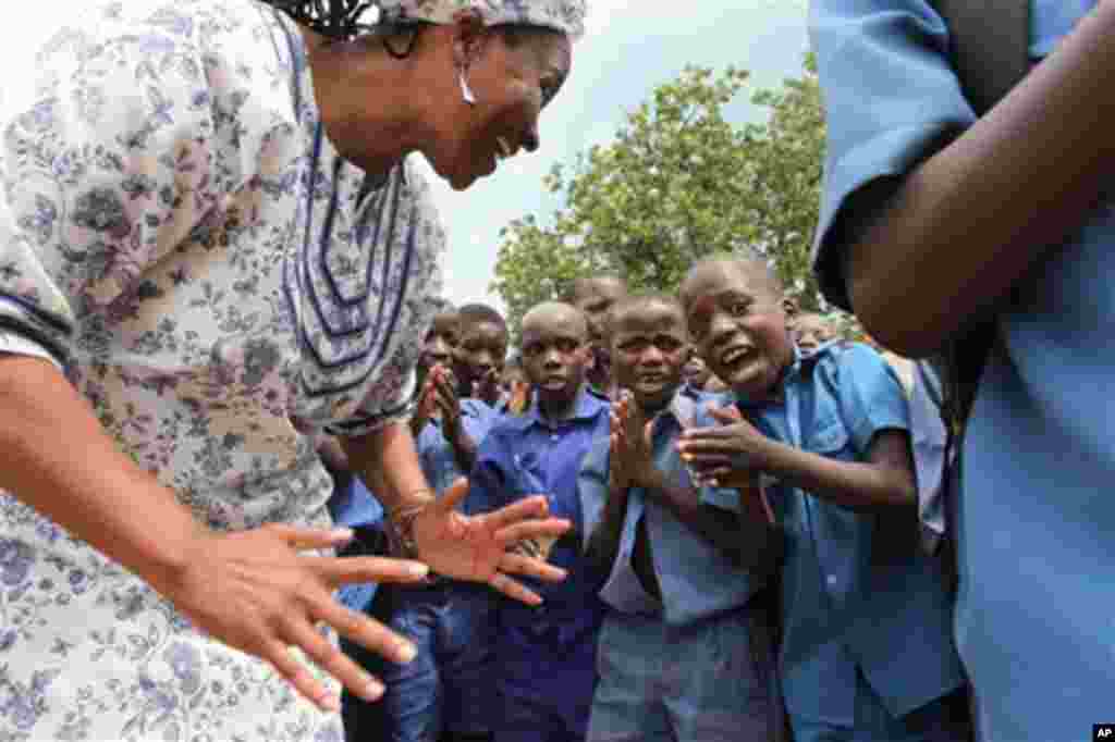 The person who was Oprah Winfrey's all time favorite guests, Tererai Trent, is seen with school children at Matau Primary School in Hurungwe, about 300 kilometres west of Harare, Zimbabwe, Friday Jan. 3, 2012.