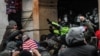 FILE - Protesters clash with police at the west entrance of the Capitol during a "Stop the Steal" protest at the U.S. Capitol in Washington, Jan. 6, 2021.