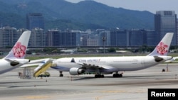 FILE - China Airlines airplanes are parked on the tarmac at Songshan Airport in Taipei, Taiwan, June 24, 2016. 