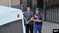 Greek army Sergeant Dimitros Kouklatzis, one of two Greek soldiers who were detained after crossing the border into Turkey, is escorted by Turkish gendarmes as he leaves a courthouse in Edirne, Turkey, on Aug. 14, 2018. 