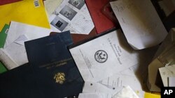 A document reading "MQ116 Protocol and US Representation Abroad" is seen in the ransacked office of the US Ambassador and Deputy Chief of Mission during a visit for the press in the vandalized US Embassy in Tripoli, Libya, September 12, 2011.