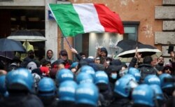 Restaurant and small-business owners take part in a protest calling for their businesses to be allowed to reopen, despite no authorization for the demonstration by the government, amid the coronavirus outbreak, in Rome, Italy, April 12, 2021.