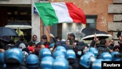 Restaurant and small-business owners take part in a protest calling for their businesses to be allowed to reopen, despite no authorization for the demonstration by the government, amid the coronavirus outbreak, in Rome, Italy, April 12, 2021.