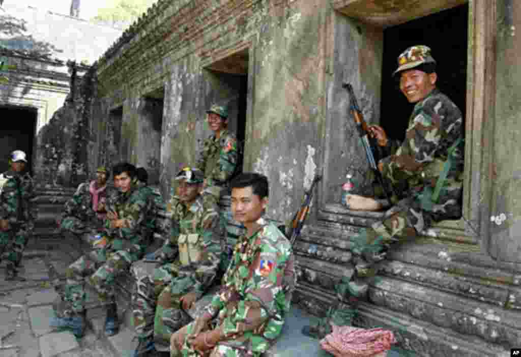 Cambodian soldiers sit at Preah Vihear temple after a brief clash with Thai troops, February 05, 2011