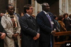 South Sudan Deputy-President Riek Machar, right, attends a prayer for peace event at the Basilica of Santa Maria in Trastevere, in Rome, April 11, 2019.