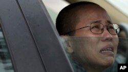 Liu Xia, wife of imprisoned Nobel Peace Prize winner Liu Xiaobo, cries in a car outside Huairou Detention Center where her brother Liu Hui has been jailed.