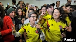 FILE - Claudia Lopez, accompanied by Angelica Lozano, speaks at an event in Bogota, Colombia, Aug. 26, 2018.