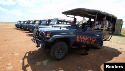 FILE - Gladys Kisemei, a guide, picks up tourists using an electric vehicle at the Maasai Mara National Reserve in Narok County, Kenya, July 16, 2021. The use of EVs is hampered in much of Africa because reliable sources of electricity can be scarce.