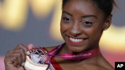 Simone Biles of the U.S. shows her gold medal after the women's vault final on the first day of the apparatus finals at the Gymnastics World Championships in Doha, Qatar, Nov. 2, 2018. 