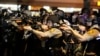 Police officers point their weapons at demonstrators protesting against the shooting death of Michael Brown in Ferguson, Missouri August 18, 2014. Police fired tear gas and stun grenades at protesters on Monday after days of unrest sparked by the fatal sh