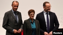 Christian Democratic Union (CDU) candidates Friedrich Merz, Annegret Kramp-Karrenbauer and Jens Spahn arrive at a regional conference in Luebeck, Germany, Nov. 15, 2018. 