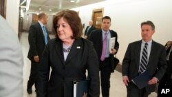 FILE - United States Secret Service director Julia Pierson enters a hearing room to answer questions before a closed meeting of the Senate Homeland Security Committee in Washington, April 1, 2014. 