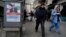 People walk past a campaign poster for Hamid Abdolmaleki, a candidate for the March 1 parliamentary election, in Tehran, Iran, on Feb. 22, 2024. This will be Iran's first election since the 2022 nationwide protests that followed the death of Mahsa Amini in police custody.