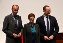 FILE - Christian Democratic Union (CDU) candidates Friedrich Merz, Annegret Kramp-Karrenbauer and Jens Spahn arrive at a regional conference in Luebeck, Nov. 15, 2018.
