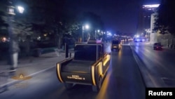 Vehicles are seen during a parade at a ceremony of a transfer of royal mummies from the Egyptian Museum in Tahrir to the National Museum of Egyptian Civilization in Fustat, in Cairo, Egypt, April 3, 2021, in this screen grab taken from a video.