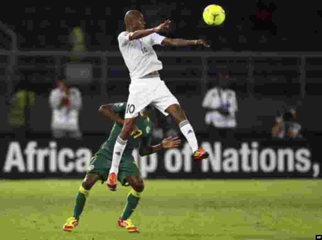 Omar Daf (bottom) of Senegal challenges Ahmed Saad of Libya during their African Nations Cup Group A soccer match at Estadio de Bata "Bata Stadium", in Bata January 29, 2012.